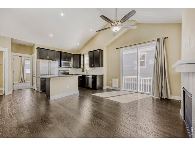 Property Photo 8 McStain model with a spacious sunny and bright open floor plan expands with vaulted ceilings and wood floors thru out. 