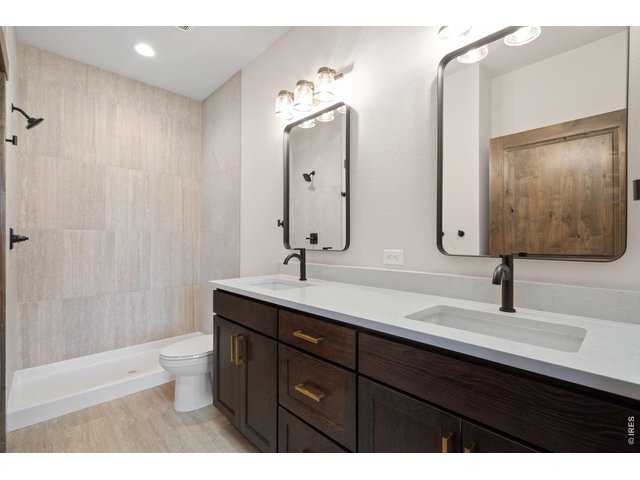 Property Photo 18 Main floor primary bathroom with quartz countertops and walk in closet