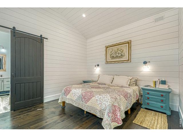 Property Photo 21 Primary Suite complete with shiplap walls and ceilings