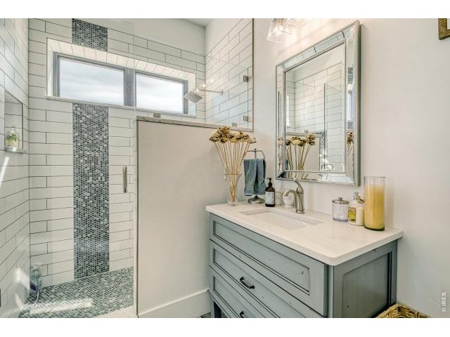 Property Photo 14 Main floor guest bathroom with custom tile shower