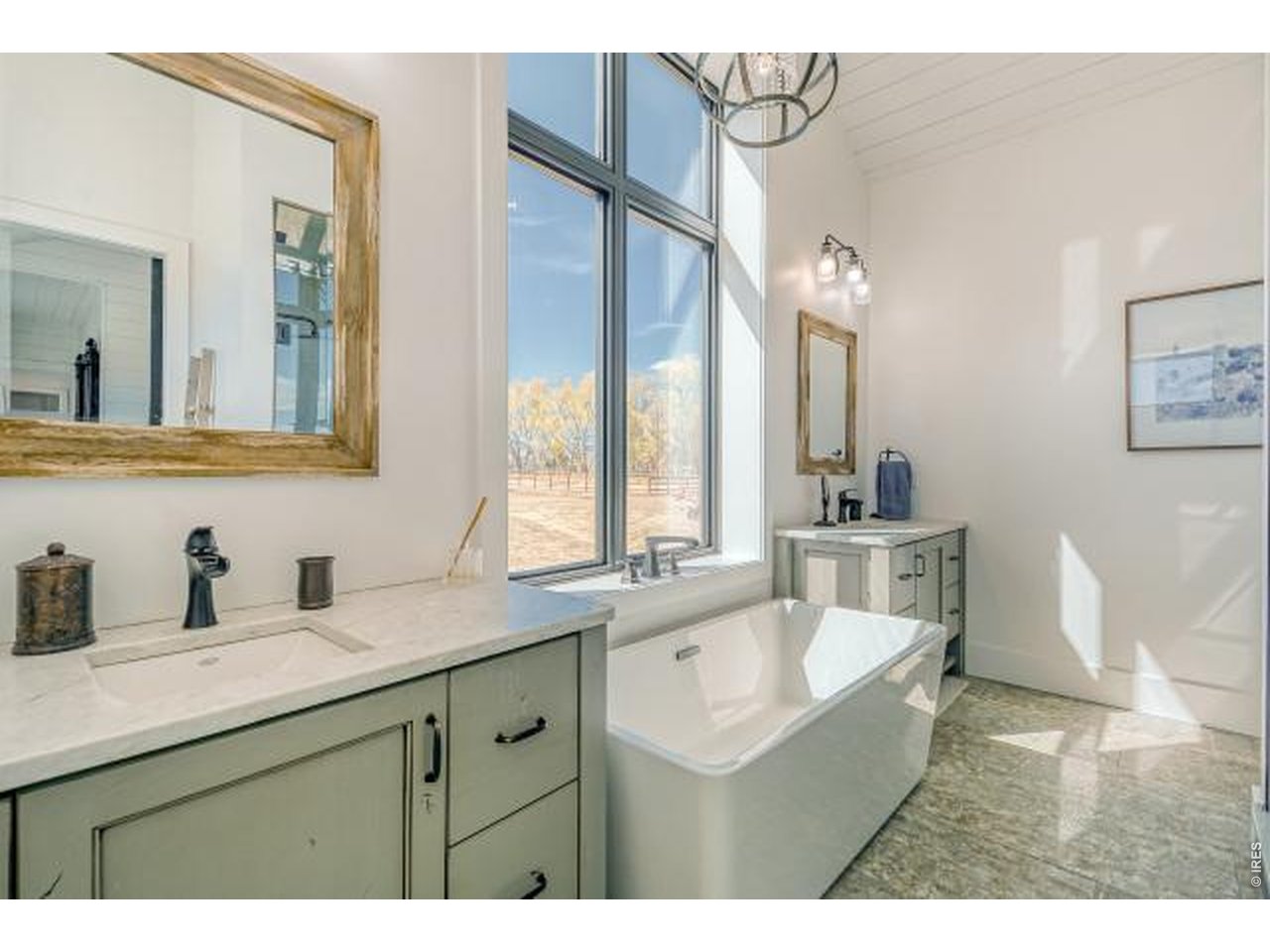 Primary bathroom with dual vanities and soaker tub