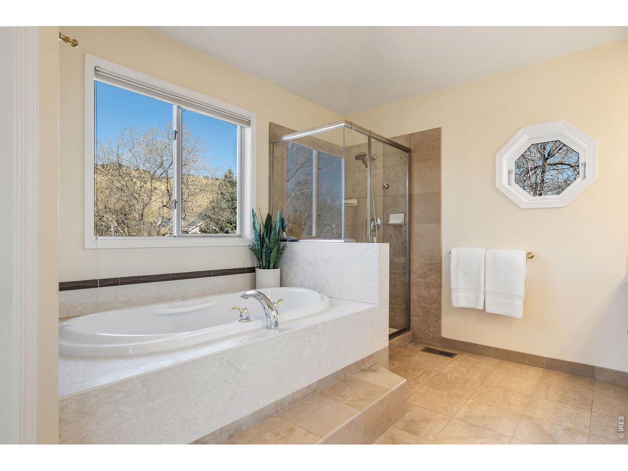 Spa-like primary bath featuring an oversized soaking tub with spectacular views!