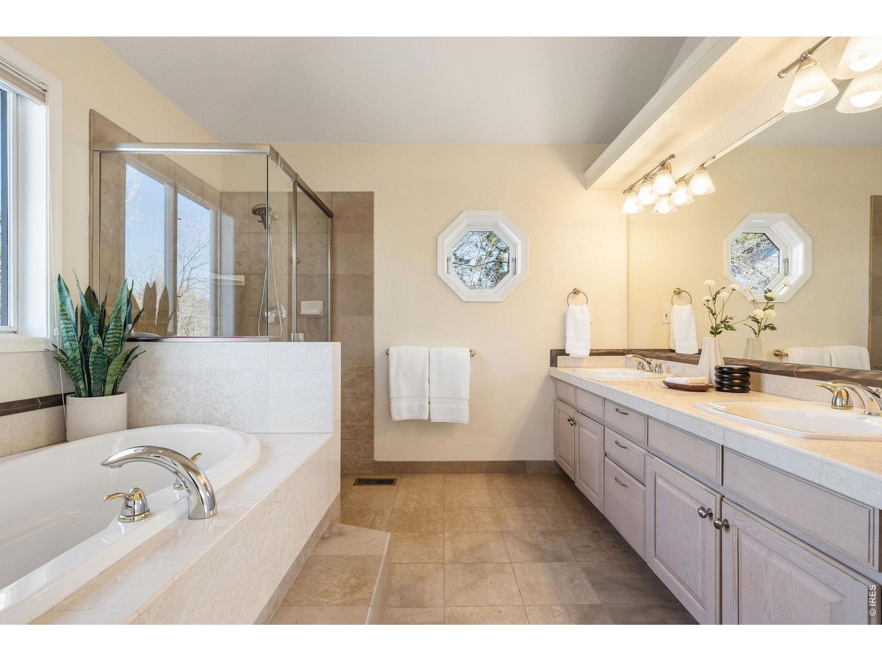 Double vanity with custom cabinetry for a tidy, organized primary bath.