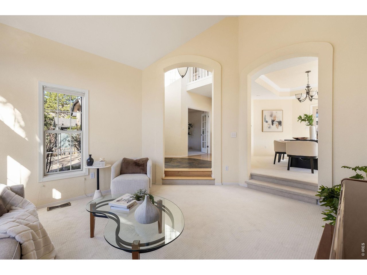 Chic living room with a view of the foyer and entryway to the dining room. 