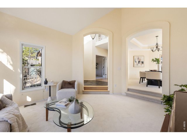 Property Photo 11 Chic living room with a view of the foyer and entryway to the dining room. 