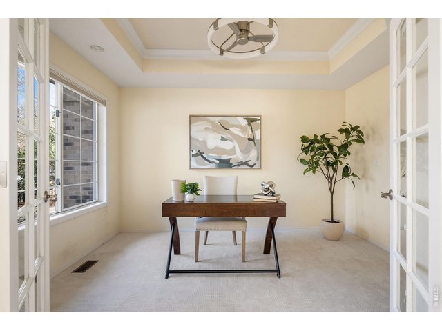 Property Photo 10 Elegant office space with custom cabinetry and designer pendant lighting. 