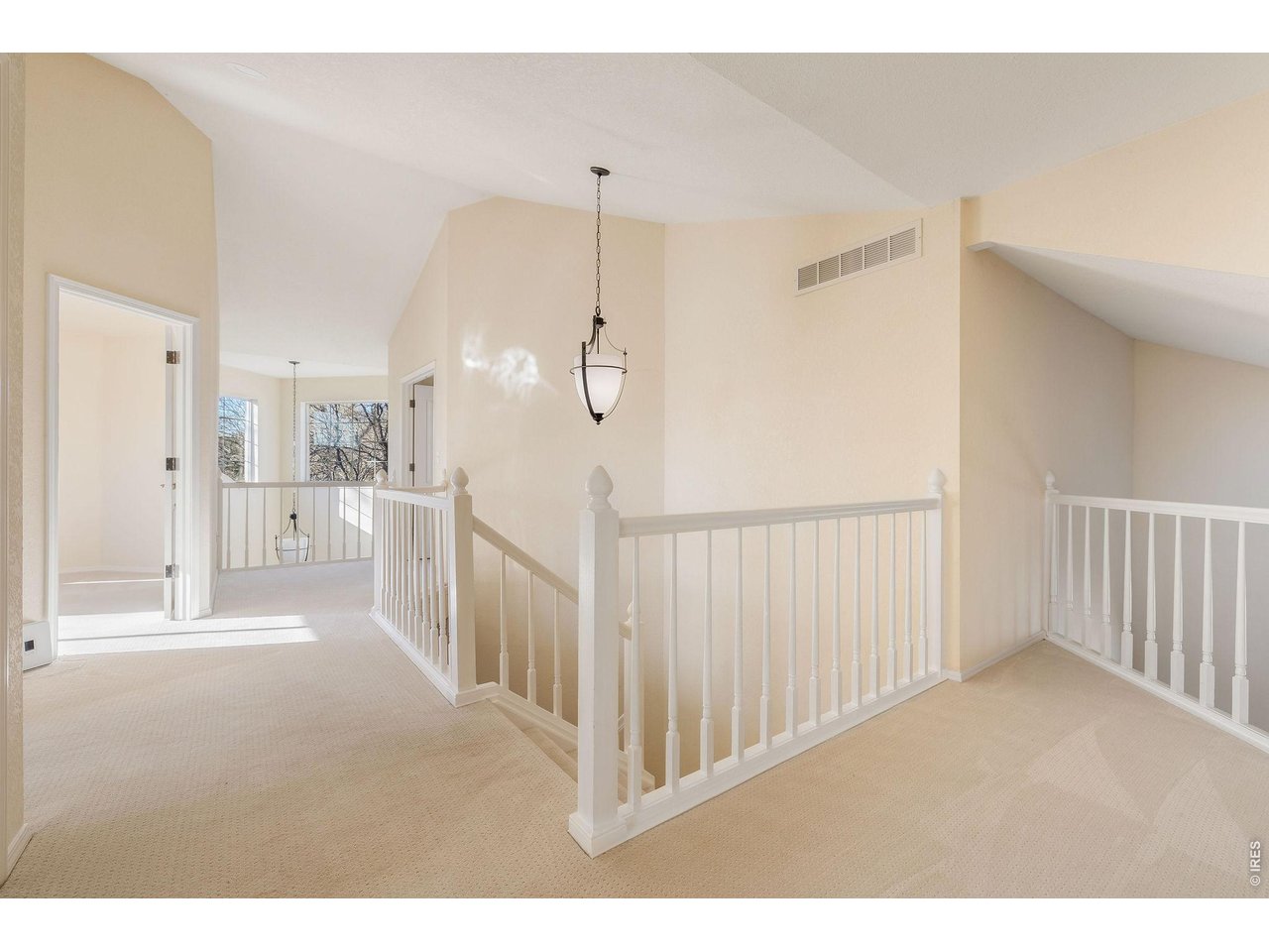 Upper level hallway connecting the primary suite, two guest suites, laundry room and linen closet.