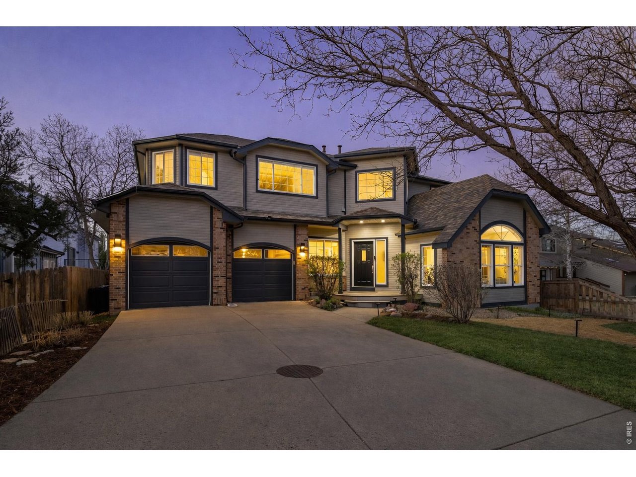 An exquisite North Boulder home backing to Wonder Lake and the sweeping foothills (Image enhanced with Ai to show greener grass)