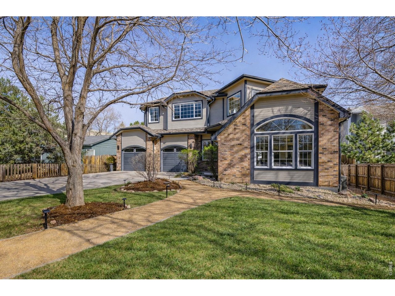 Immaculate landscaping and newly updated landscape lighting. (Image enhanced with Ai to show greener grass)