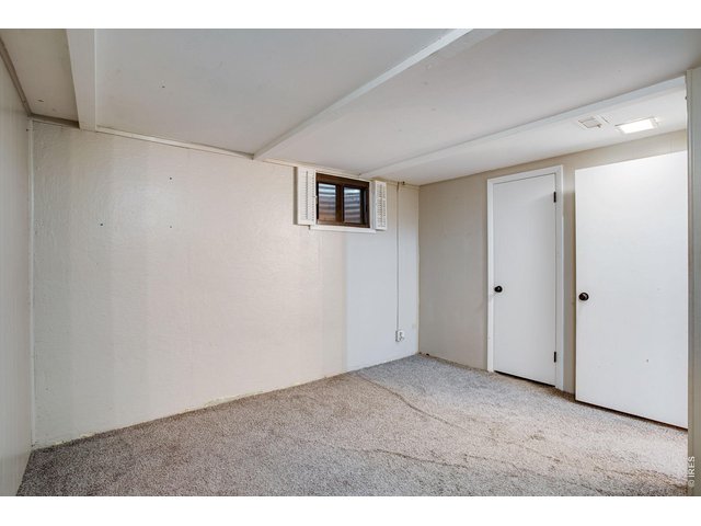 Property Photo 33 Basement: Bedroom 3 showing door to large walk-in closet.