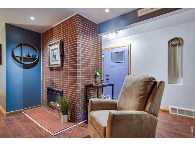 Property Photo 16 Living Room: They don't make them like this anymore. The blue front door is new as of 2025 and has a nice storm door so you can let even more light in.