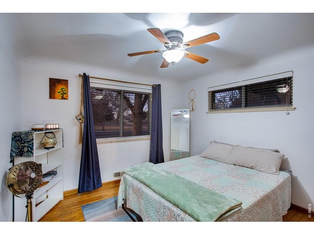 Property Photo 22 Bedroom 2: Windows face north and east and feature those original warm hardwood floors.