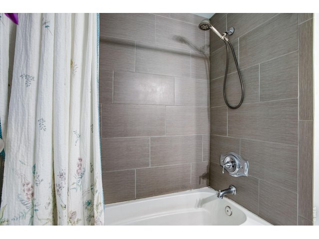 Property Photo 21 Shared Hall Bath: Surround for the tub and shower has all been updated.