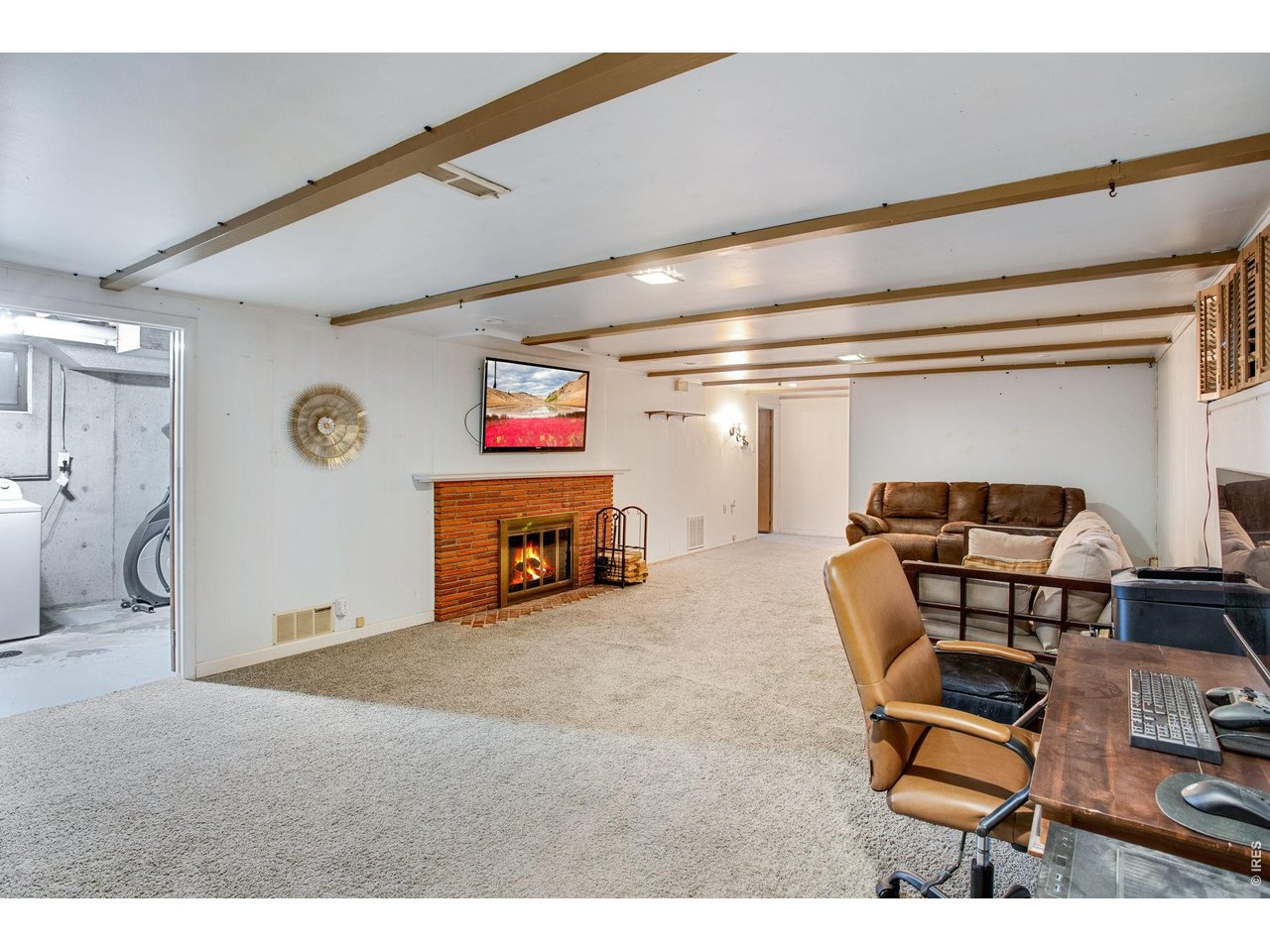 Basement: Huge 15'x24' Family Room with wood burning fireplace. You can see the laundry to the left.