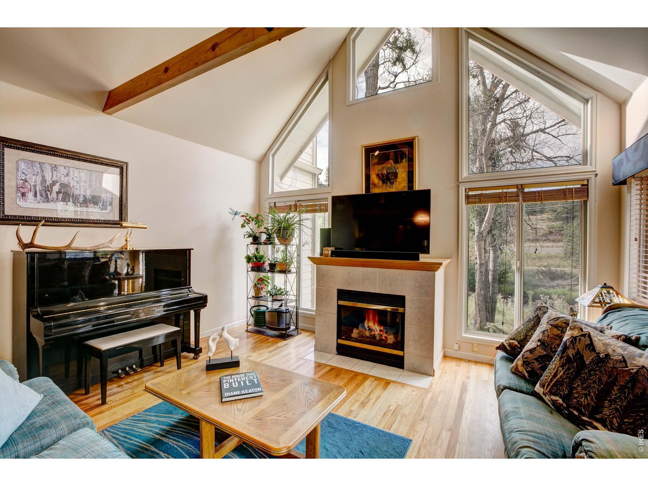 Natural light and cathedral ceilings by the fireplace.