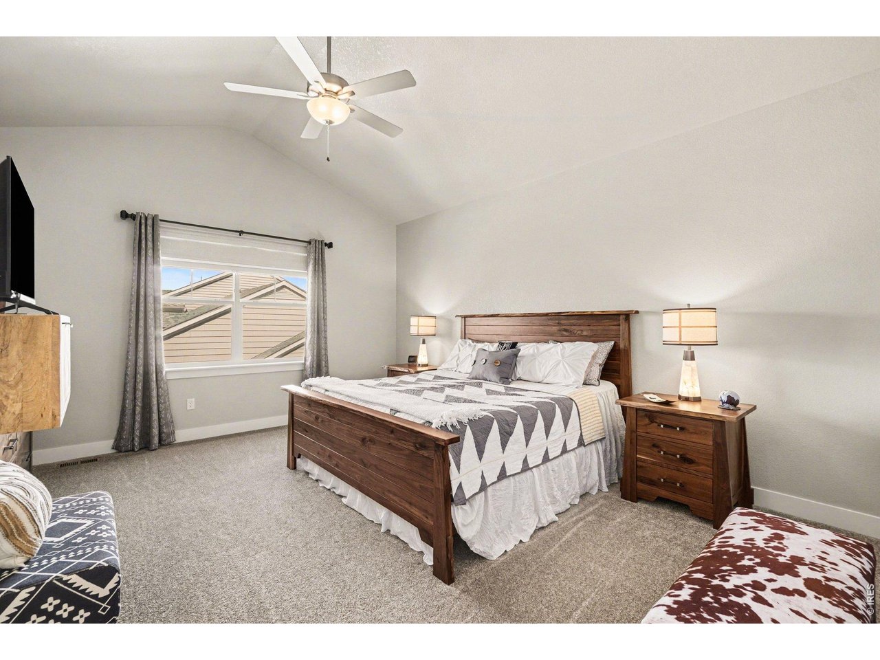 Primary bedroom with vaulted ceiling