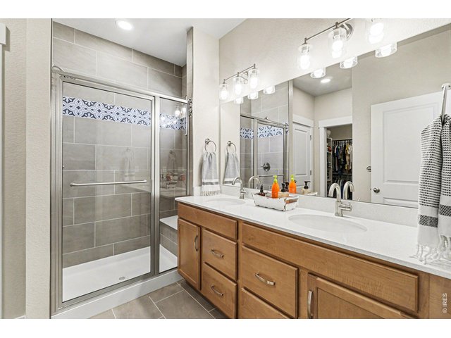 Property Photo 22 Primary bathroom with tile shower and double sinks
