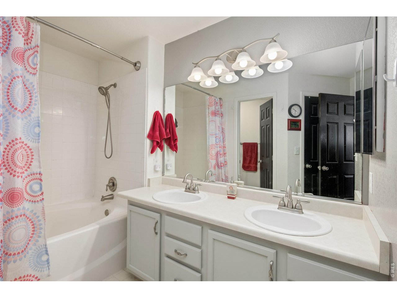 Full bathroom with soaking tub, large walk-in closet, & linen closet