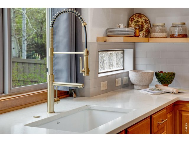 Property Photo 8 Large cast iron sink, full tile splash- combo of modern open shelving