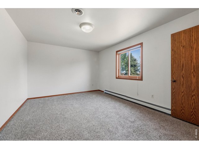 Property Photo 27 Comfortable upper-level bedroom with a clean, functional layout.