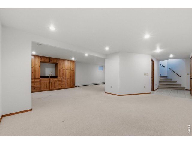 Property Photo 32 Spacious basement rec room. Perfect for a second living area, game room, or movie nights