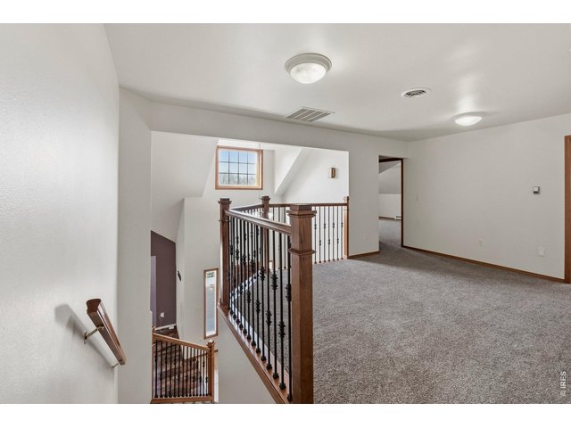 Property Photo 24 Spacious loft offering flexible use as a second living area, office, or play space.
