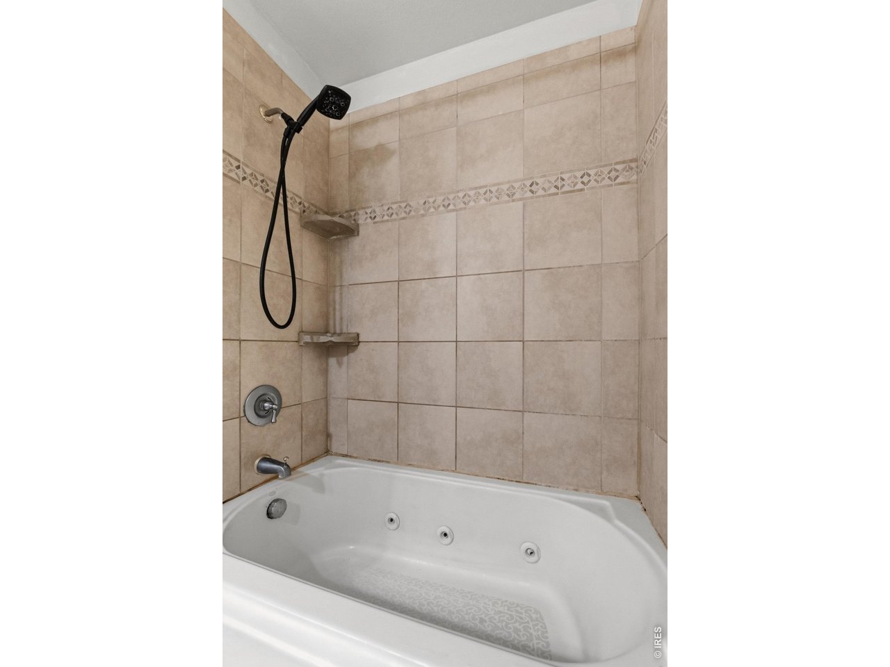 Relaxing ensuite bath featuring a jetted tub for a spa-like feel.