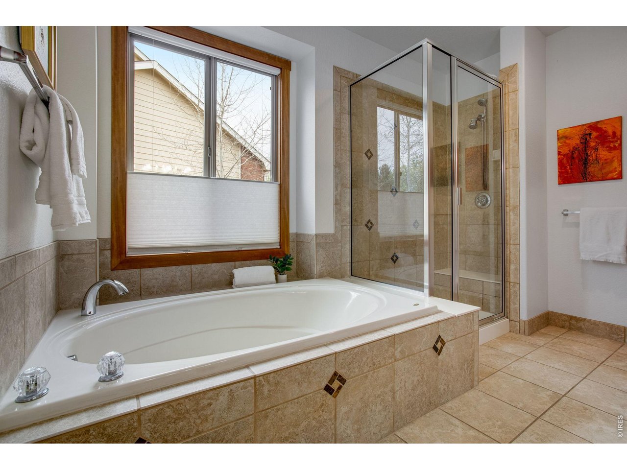 Large Soaking tub and shower - pretty neutral tiles throughout and top down bottom up privacy blind. 
