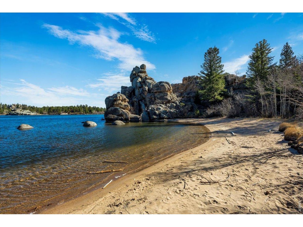 Walk just down the road to a secluded beach/cove behind beautiful rock outcroppings on Hiawatha Lake!