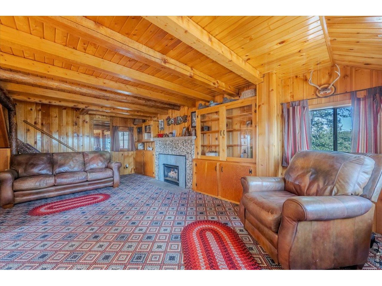 Living room with two heat sources and beautiful wood finishes.