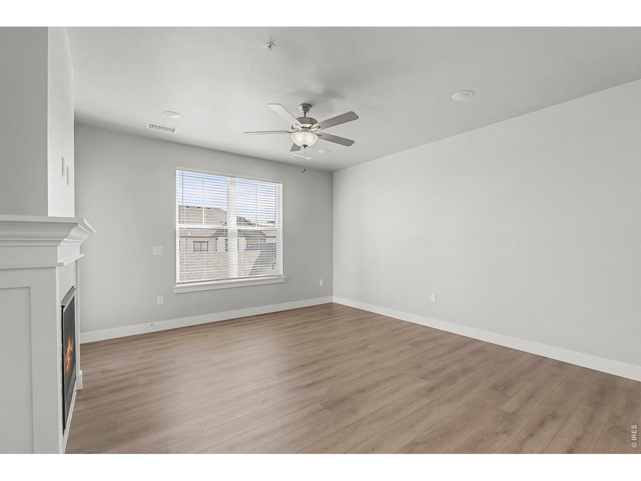 Property Photo 5 Spacious living room with ceiling fan included.