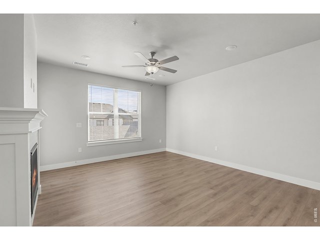 Property Photo 5 Spacious living room with ceiling fan included.
