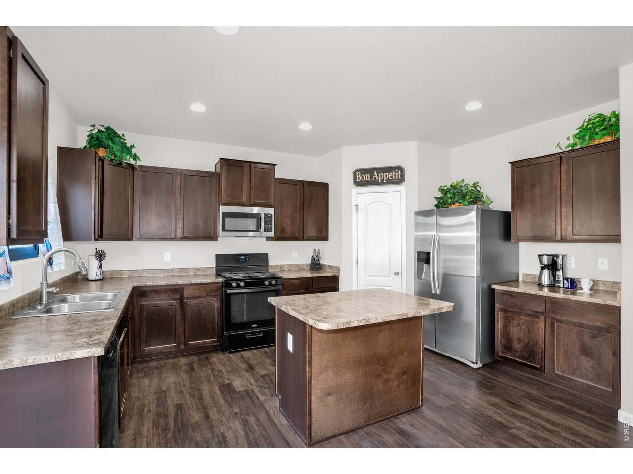 The large kitchen has an island prep space (large enough for 2 stools), GE stainless steel appliances, ample cupboards and counterspace and a large pantry!!.