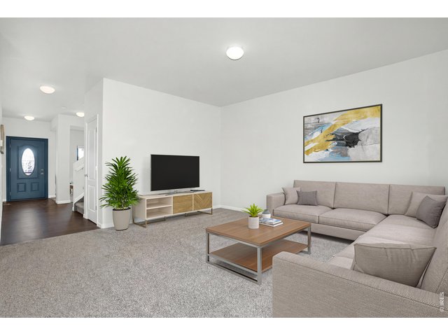 Property Photo 5 This bright and refreshed living room showcases crisp white walls that creat a clean, airy back drop for any style. Brand new plush carpet adds warmth and comfort underfoot. 