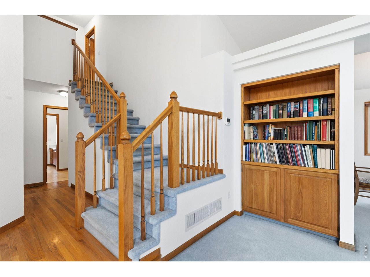 Staircase and living room with built in cabinets. 