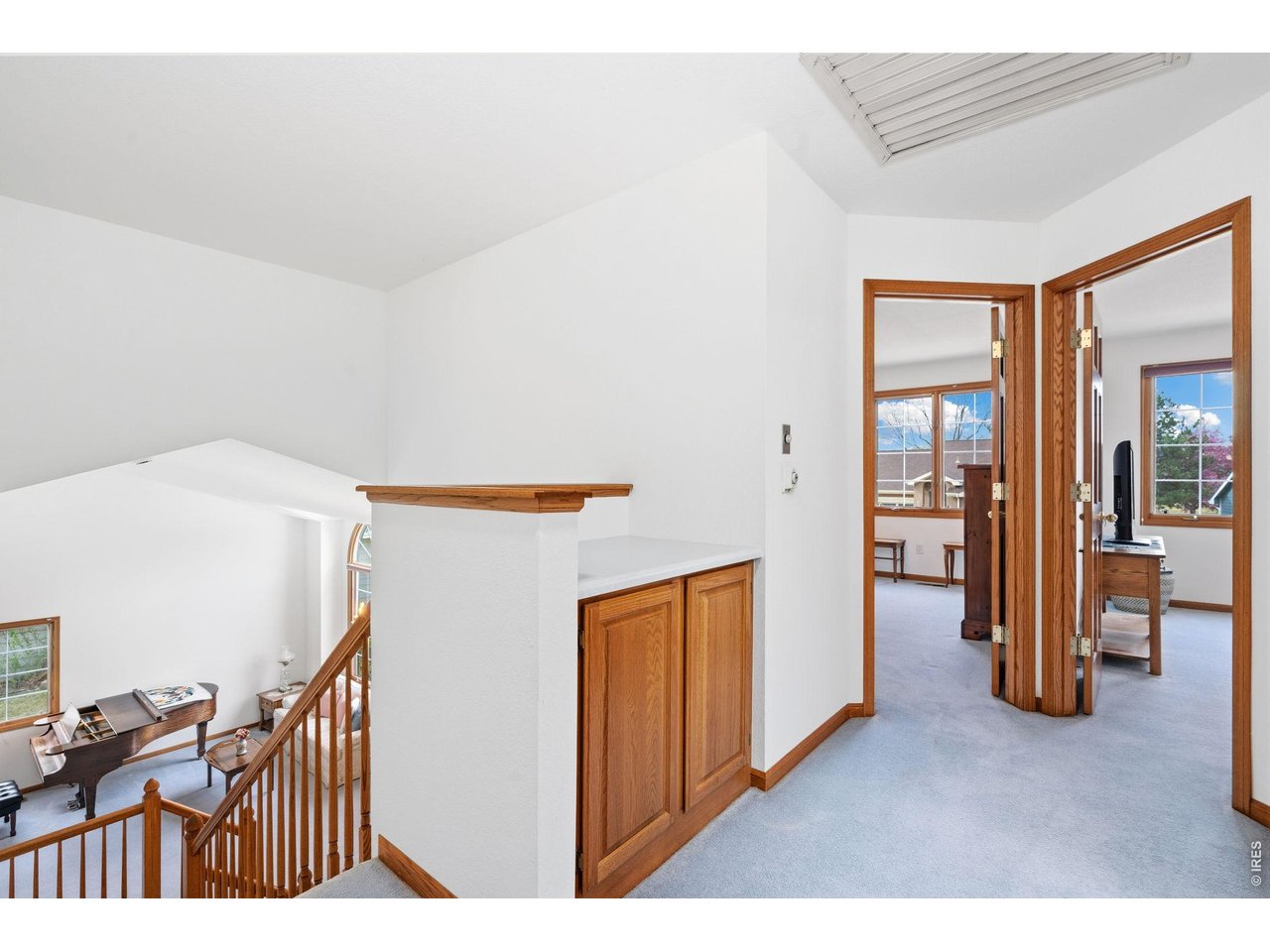 Staircase leads to the primary bedroom and additional two bedrooms. 