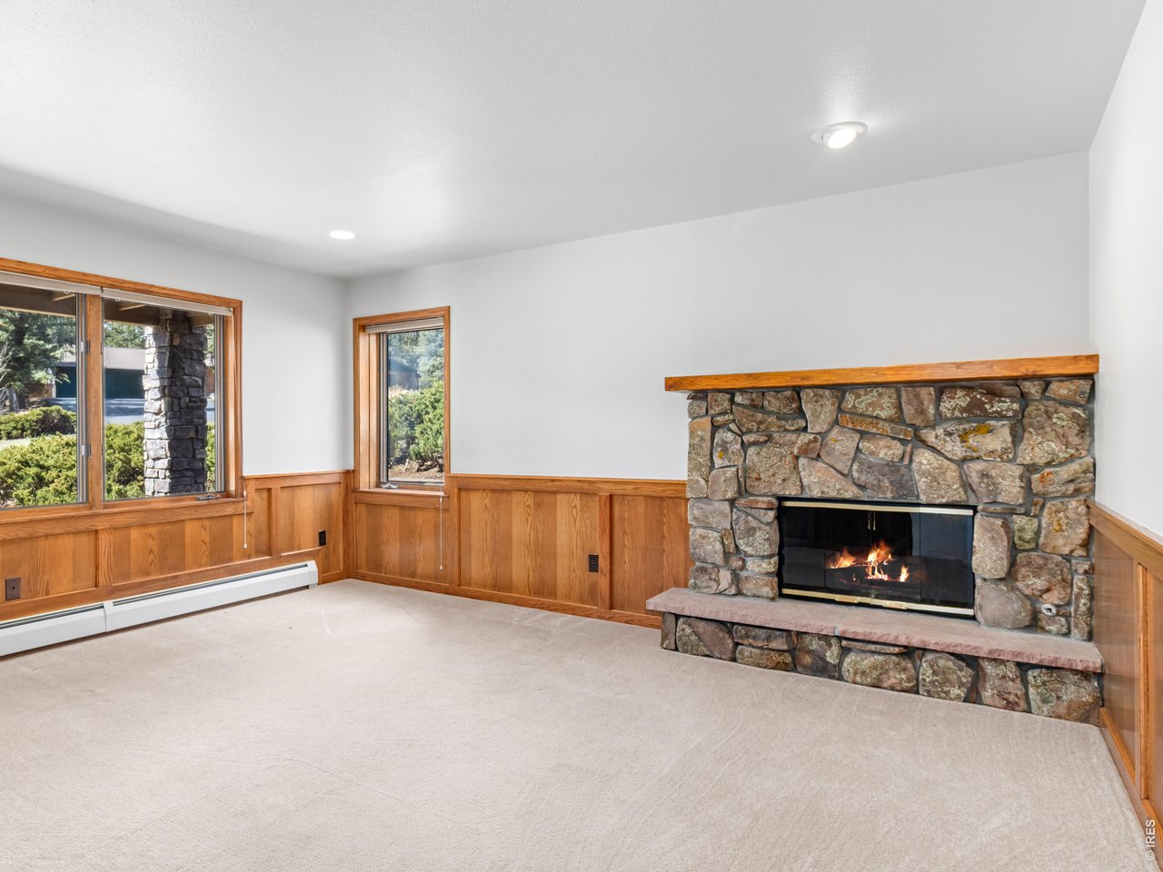 Lower level office/4th bedroom with moss rock fireplace