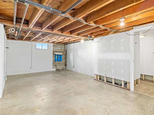 Property Photo 22 Downstairs, a three-quarter bath in need of some re assembly and a completely unfinished basement offer endless possibilities for expansion, storage, workshop space, or future customization