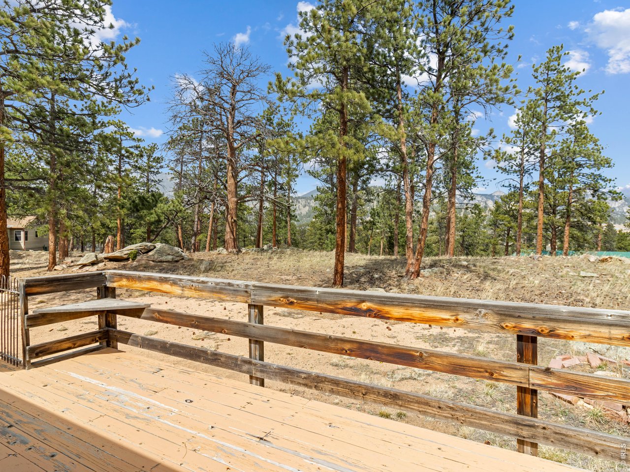 Set on 0.84 acres with southern exposure, striking rock outcroppings, and towering pine trees