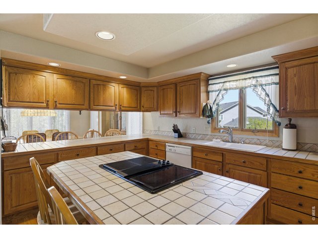 Property Photo 13 Tiled Center Island with Built-In Jenn Air Grill Cooktop and Full Length Breakfast Bar.