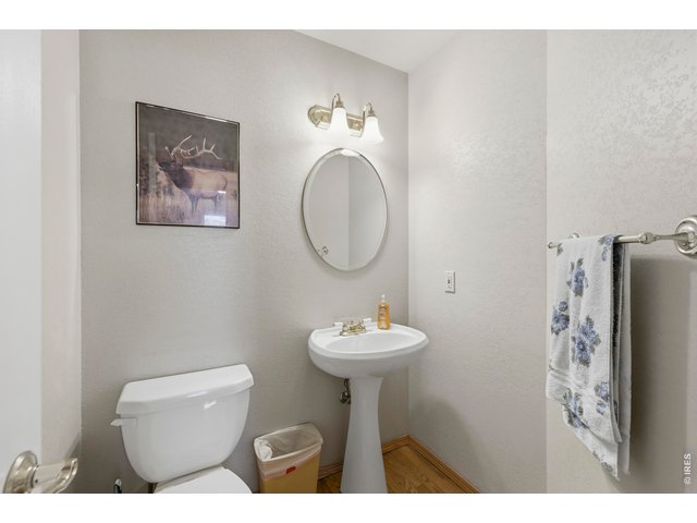 Property Photo 19 Main Floor Half Guest Bath with Wood Floors
