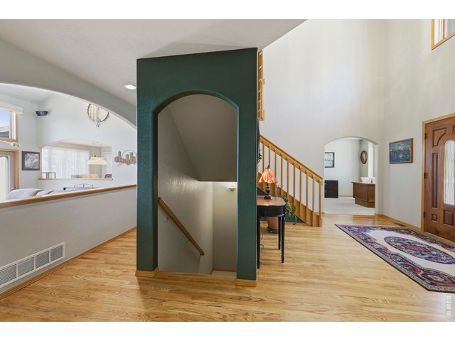 Property Photo 8 View from the Entry Way looking at both the Front Door and the Arched Opening to the Family Room