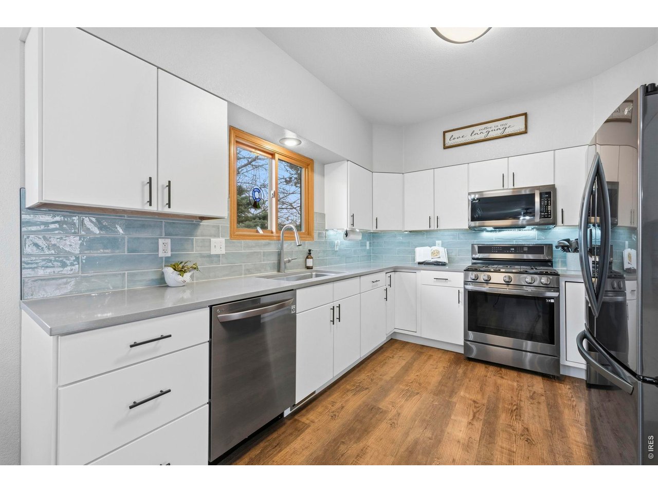 Fully updated kitchen with stone countertops and black stainless appliances including gas range!