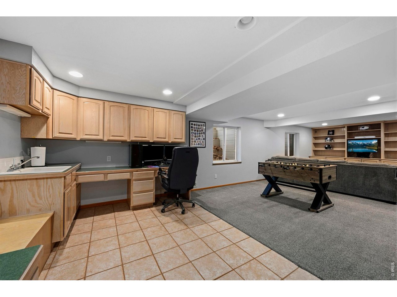Large rec room in basement with lots of built-ins