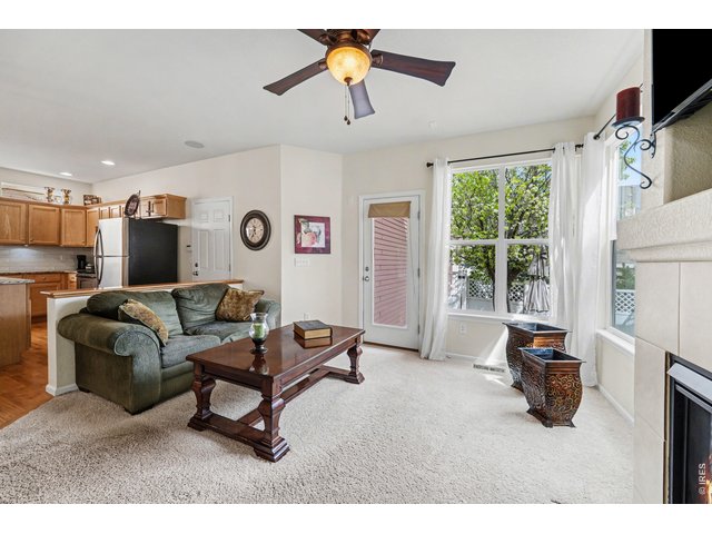 Property Photo 17 Cozy family room with fireplace, flowing into the bright kitchen