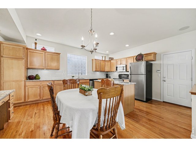 Property Photo 10 Expansive kitchen with granite counters, stainless appliances, and hardwood floors