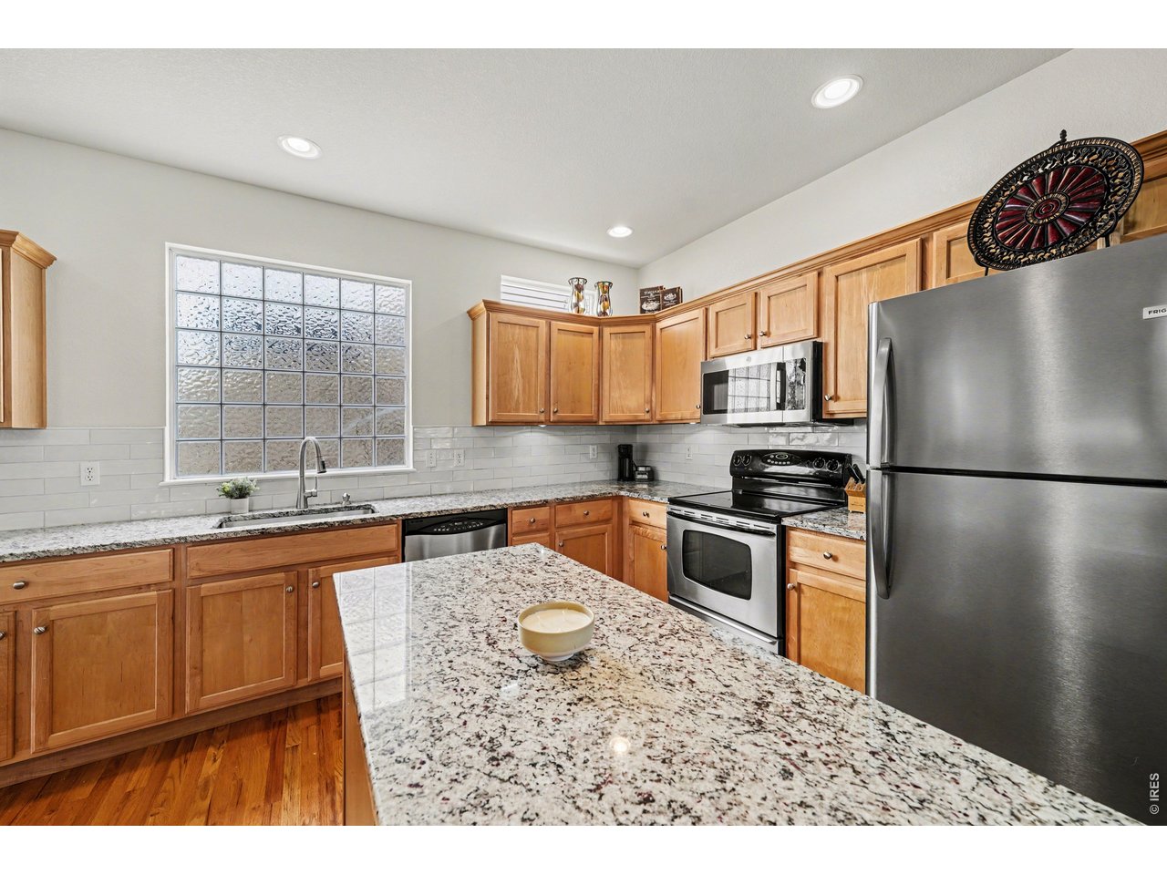 Tile backsplash, modern single-basin sink, and expansive counter space