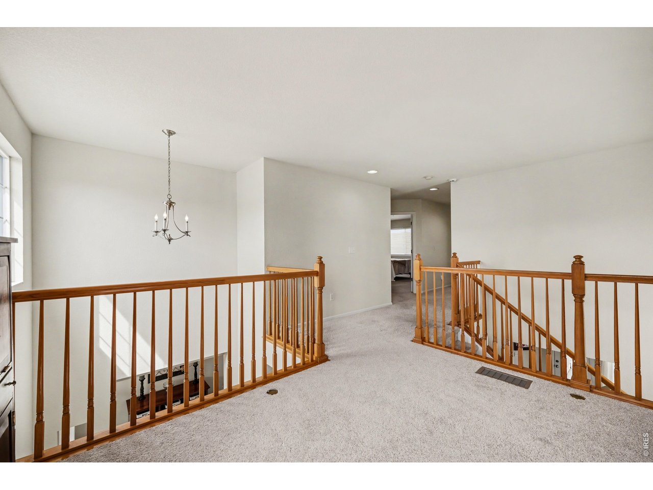 Light-filled upper landing overlooking the main level, leading to the private bedrooms