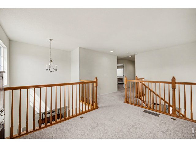 Property Photo 19 Light-filled upper landing overlooking the main level, leading to the private bedrooms