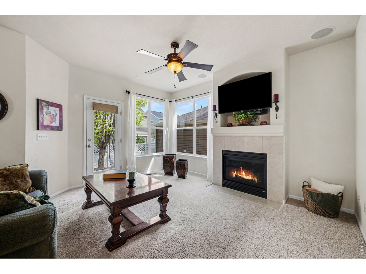Inviting family room anchored by a tiled gas fireplace and built-in media nook.